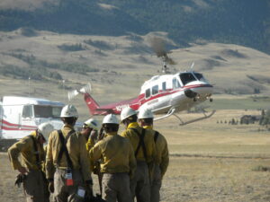 Crews on the Miner Paradise Complex wait to be shuttled to the line by helicopter. Firefighters made good progress Monday and weather looks favorable for more good work Tuesday.